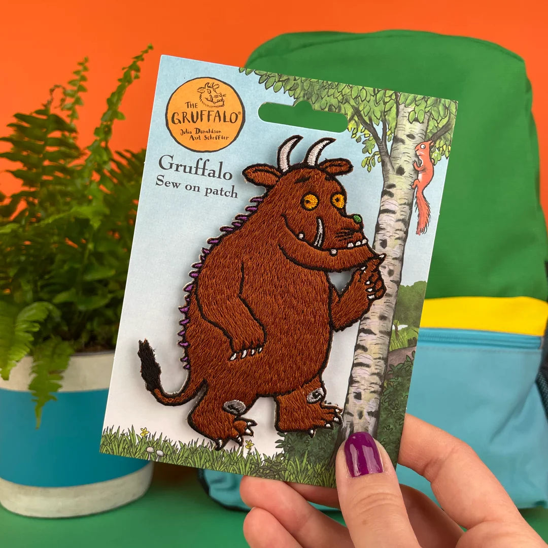a hand holding a card with a picture of a troll on it
