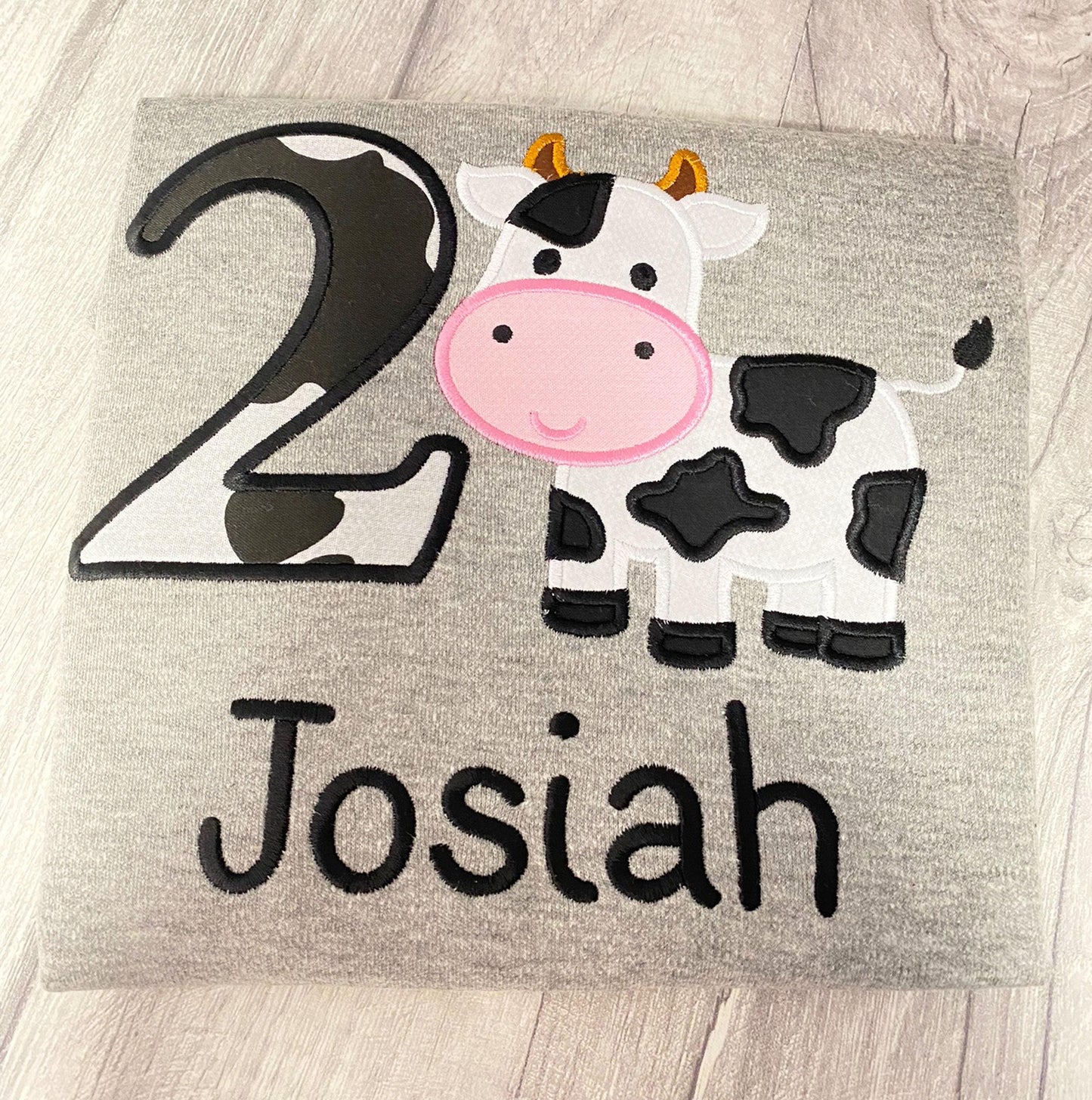 a picture of a cow with the number two on it