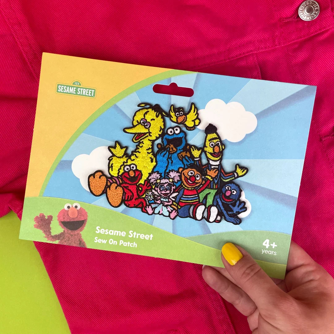 a person holding a card with a picture of cartoon characters on it