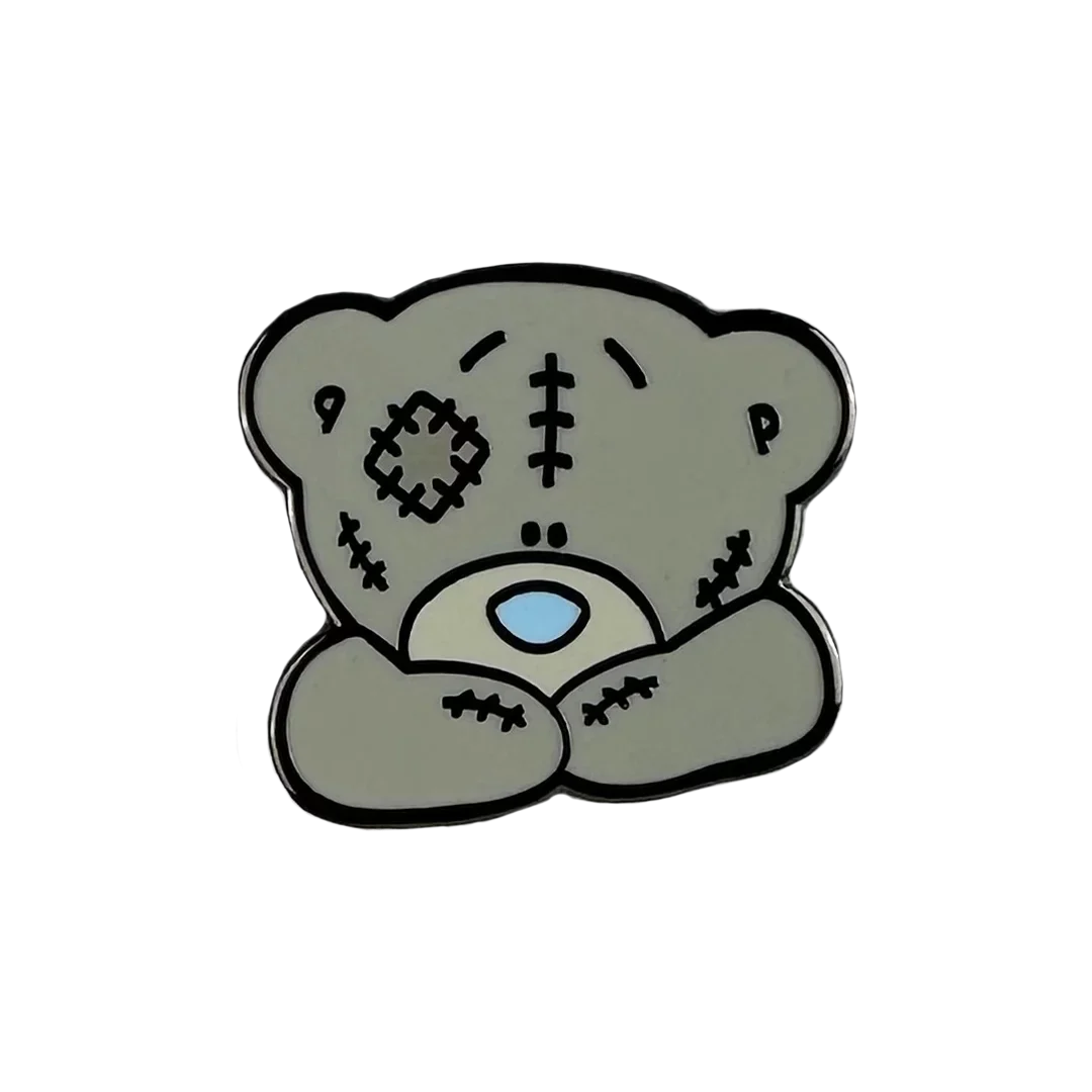 a sticker of a teddy bear with a cross on it