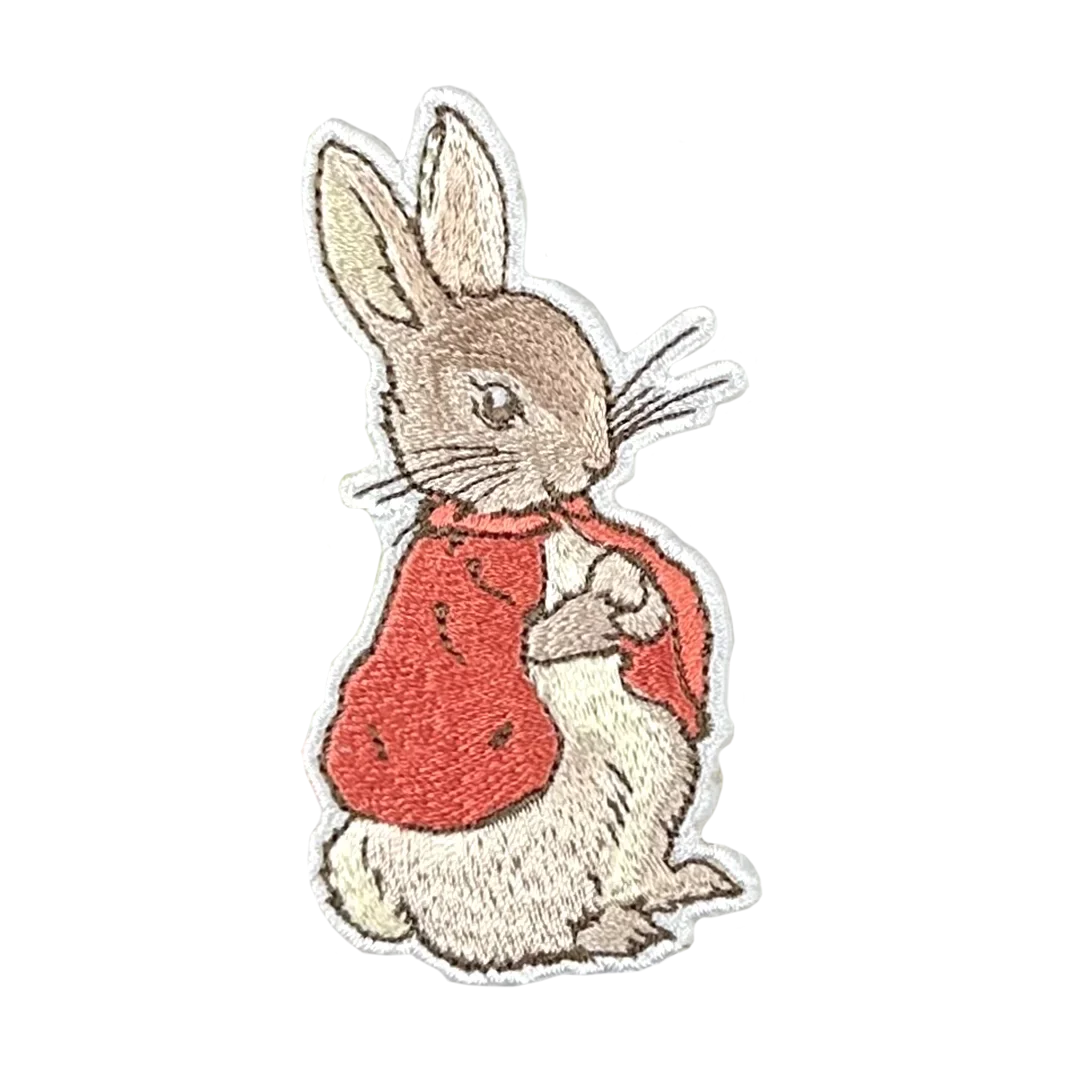a white rabbit with a red shirt on