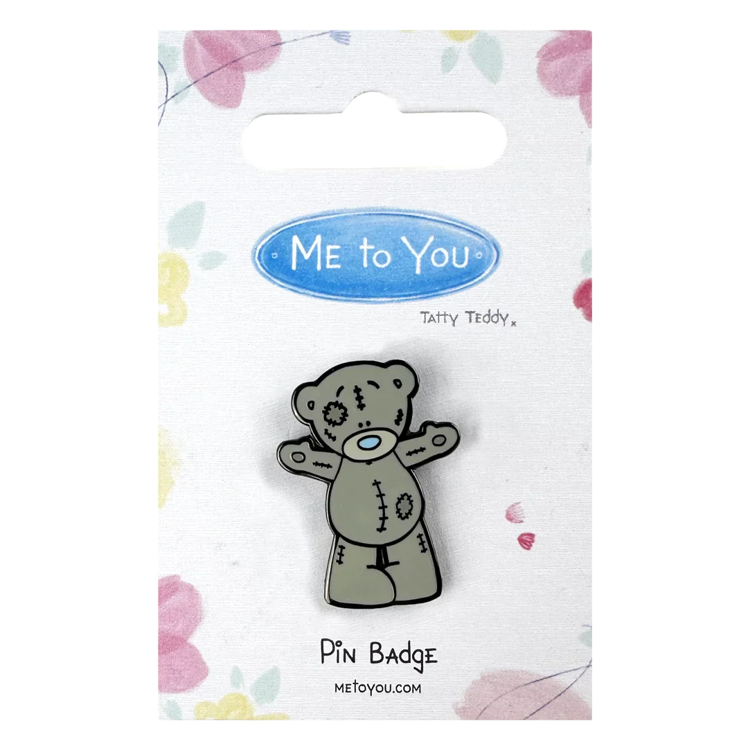 a pin badge with a teddy bear on it
