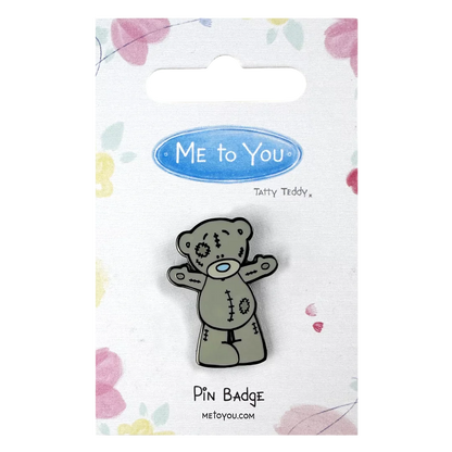 a pin badge with a teddy bear on it
