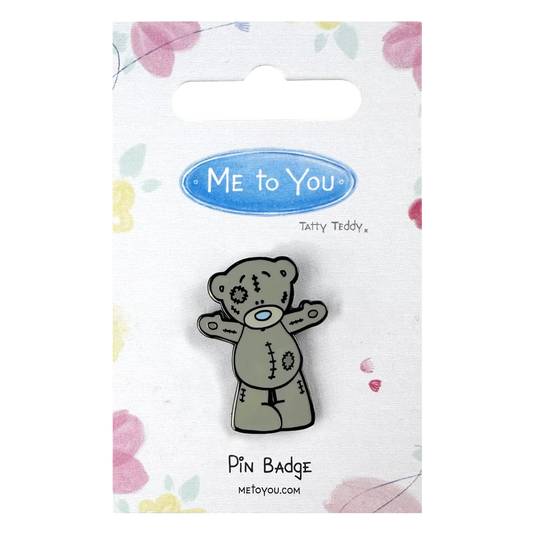 a pin badge with a teddy bear on it
