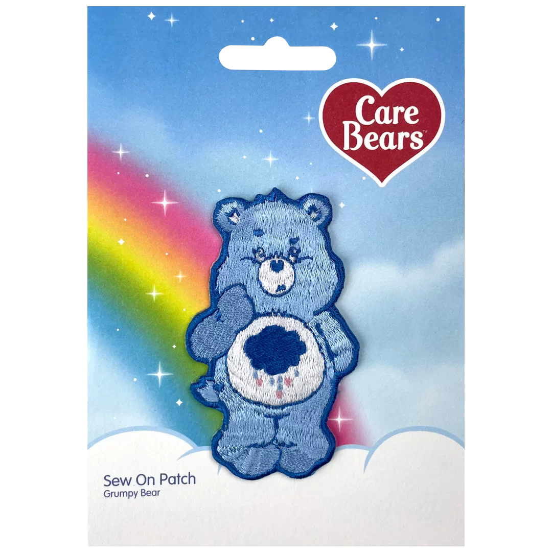a blue teddy bear with a rainbow in the background