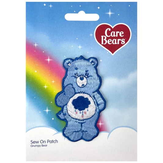 a blue teddy bear with a rainbow in the background