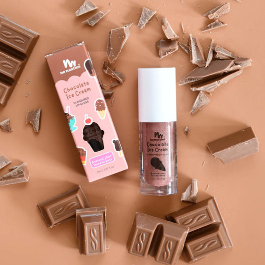 a chocolate bar, lip bale, and lip glosses on a table