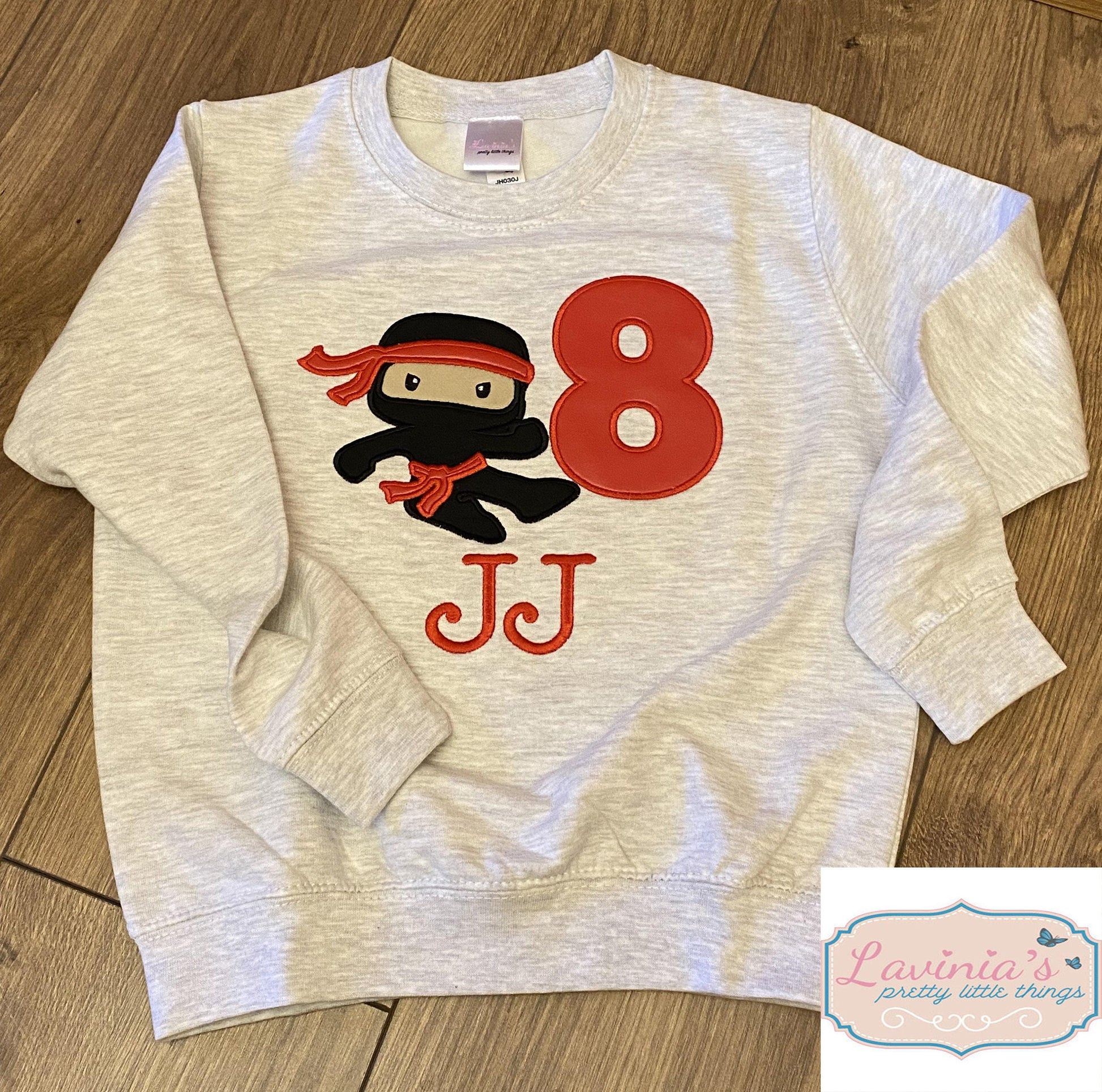 a white sweatshirt with a cartoon character on it