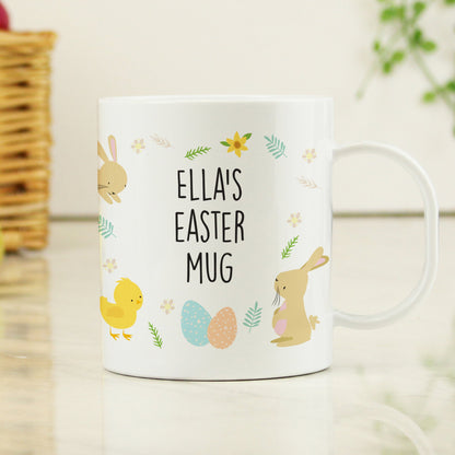 a white coffee mug with a bunny and chick on it