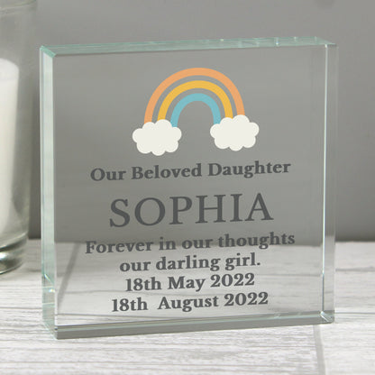 a glass block with a rainbow and clouds on it