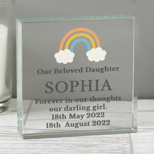 a glass block with a rainbow and clouds on it