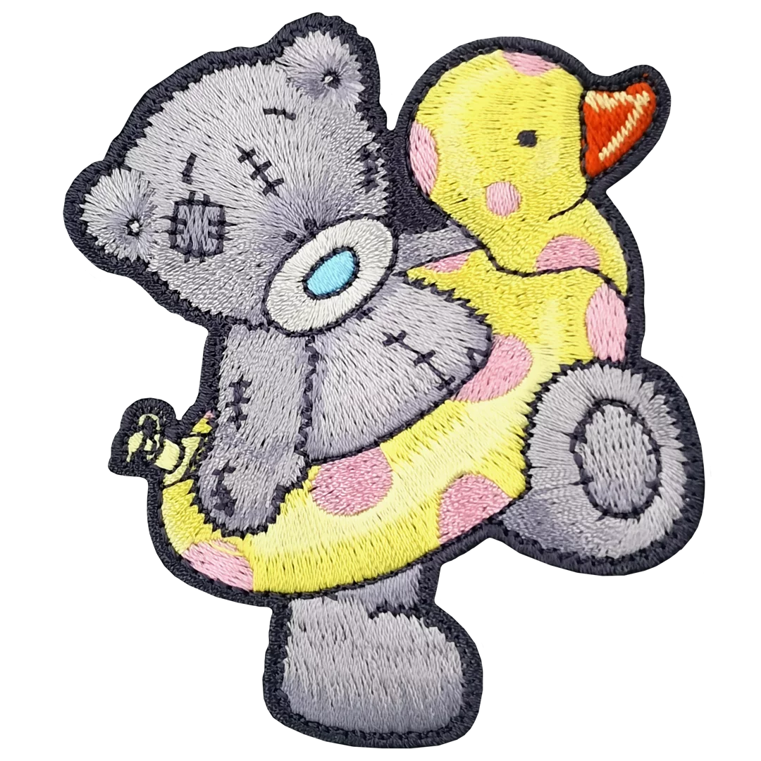 a gray teddy bear holding a yellow rubber duck