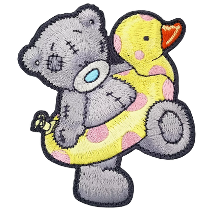 a gray teddy bear holding a yellow rubber duck