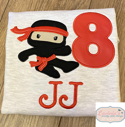 a white shirt with an image of a ninja on it