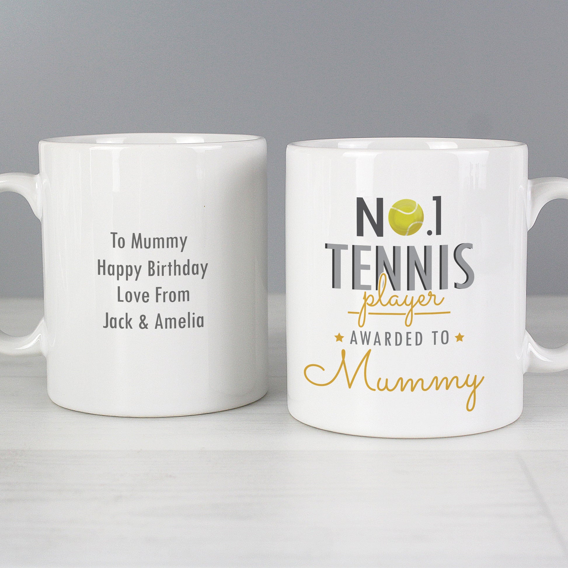 two personalized coffee mugs sitting on a table