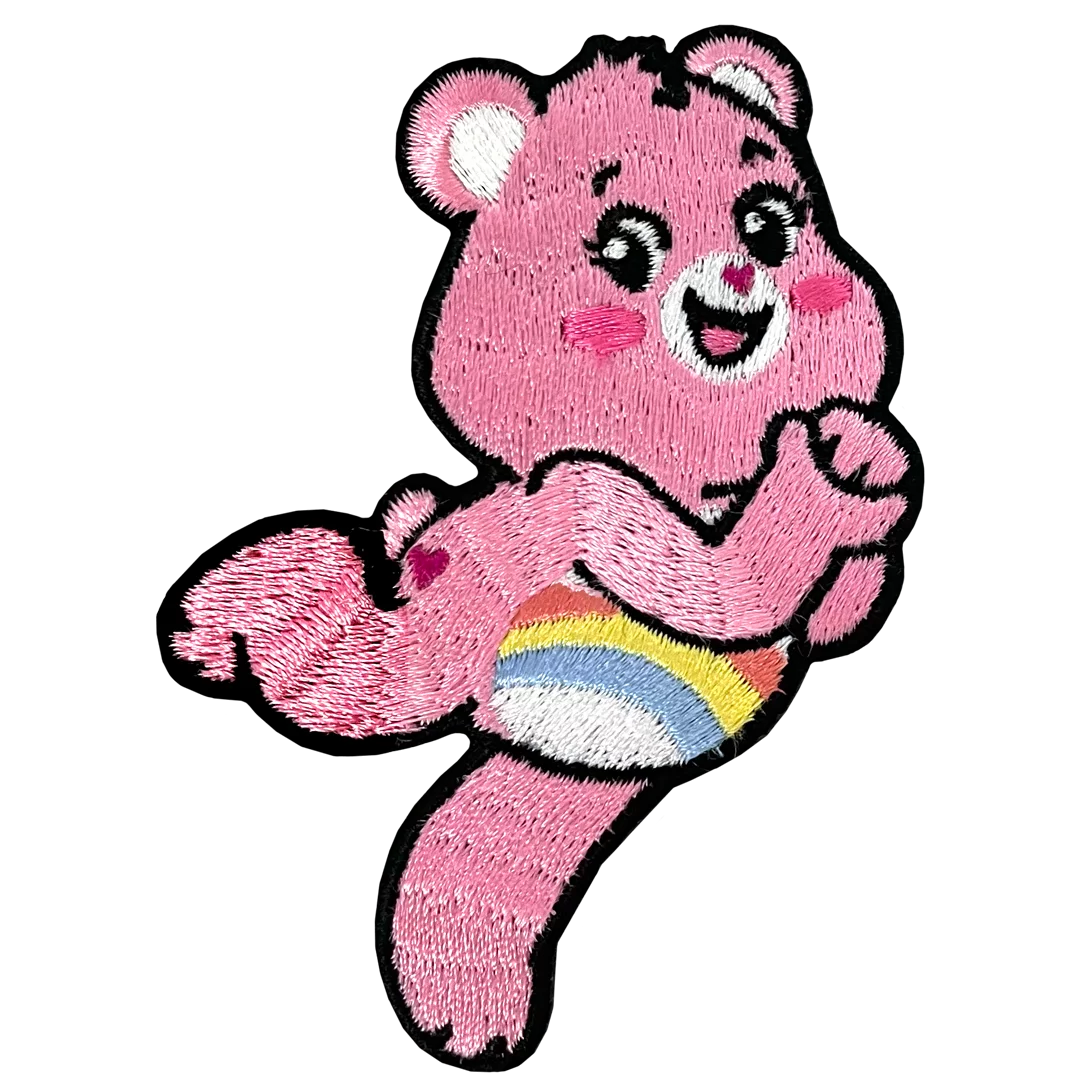 a pink teddy bear holding a rainbow ball