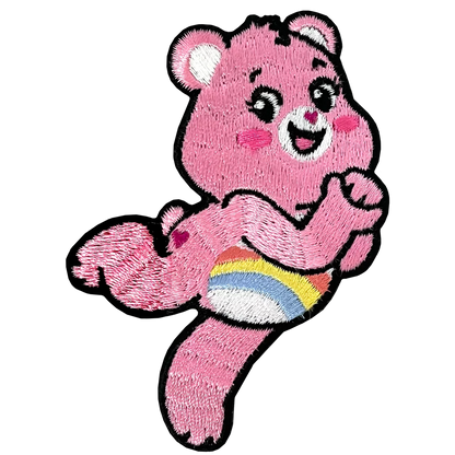 a pink teddy bear holding a rainbow ball