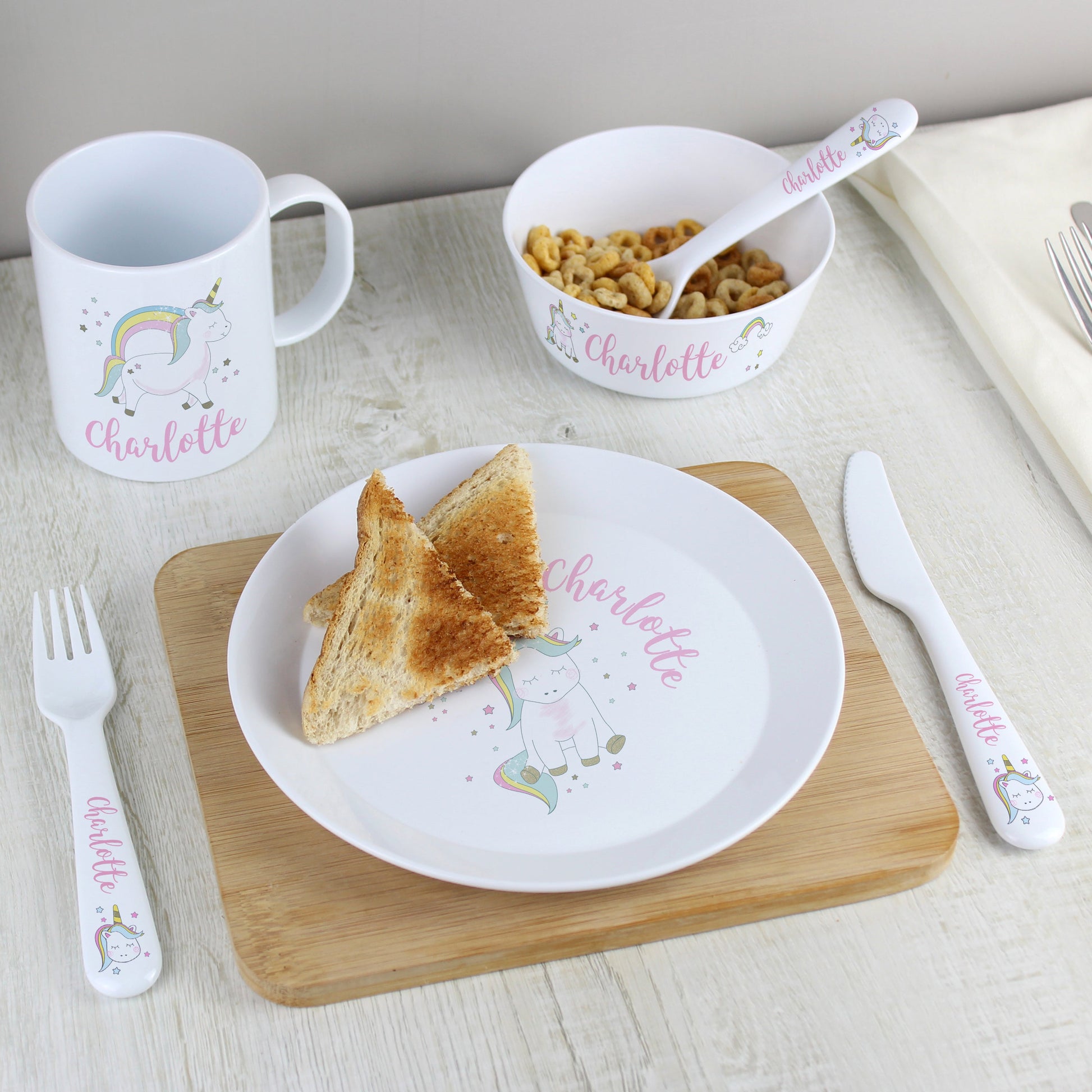 a white plate topped with a piece of bread next to a cup of coffee
