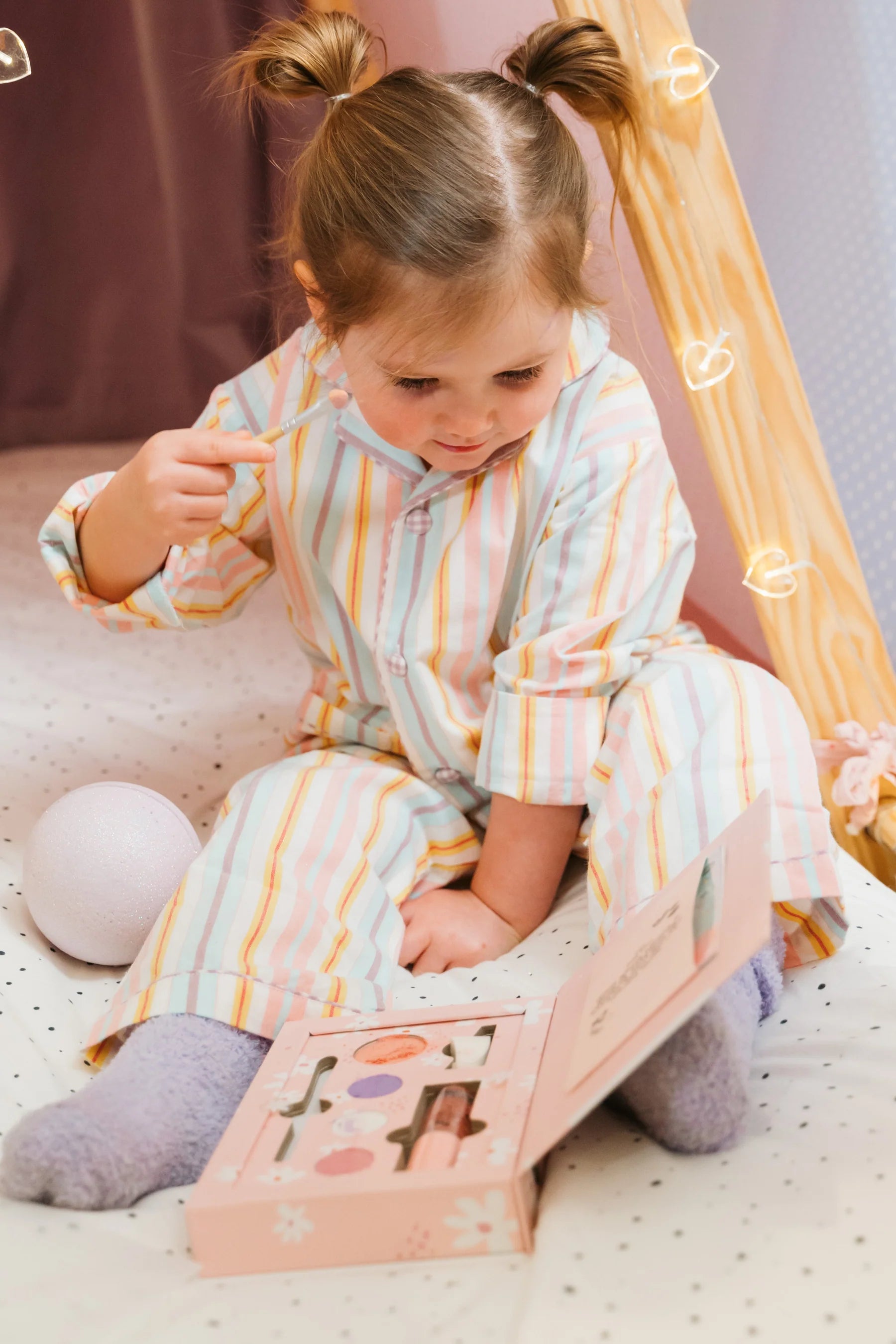 a little girl that is sitting down with a book