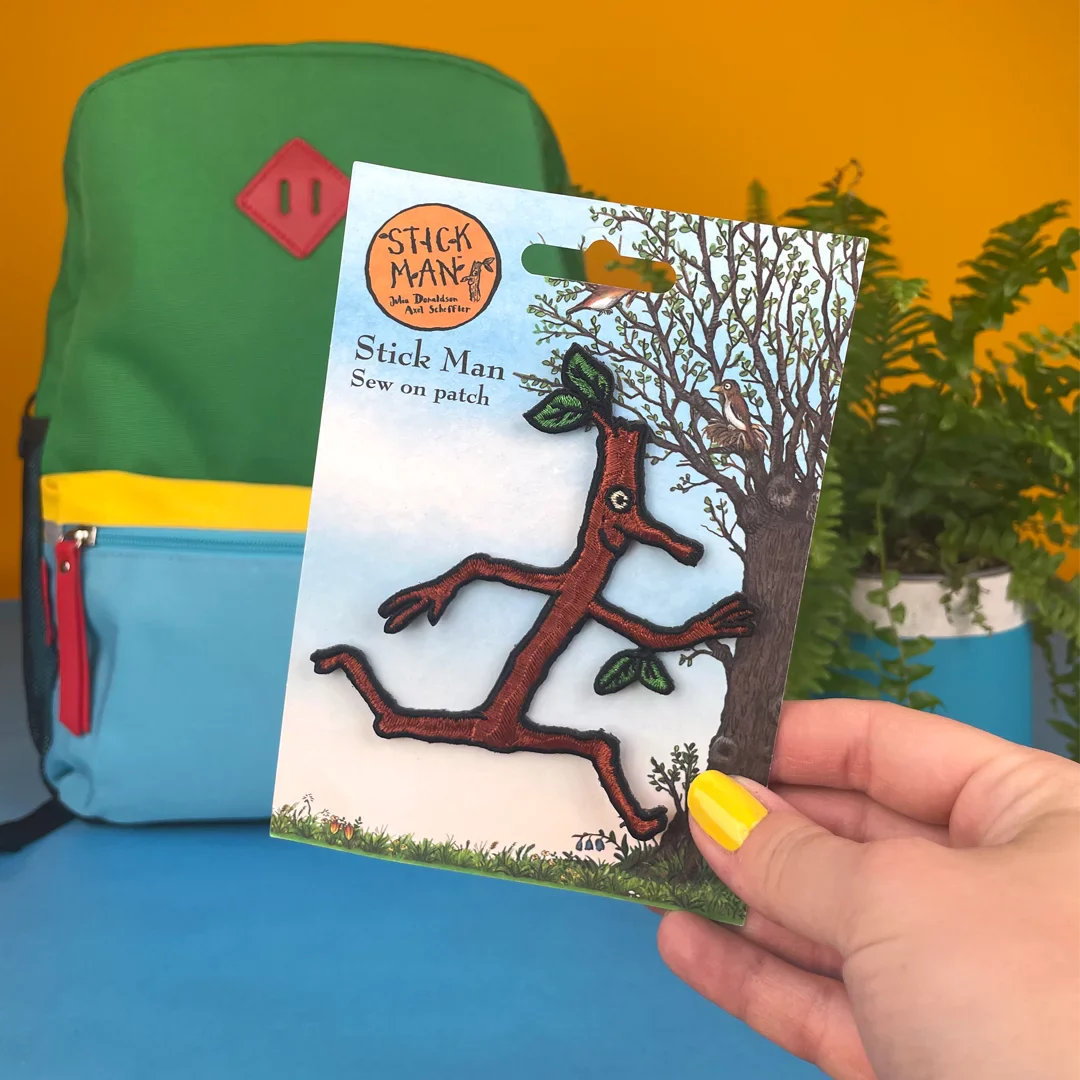 a person holding a book with a picture of a tree on it