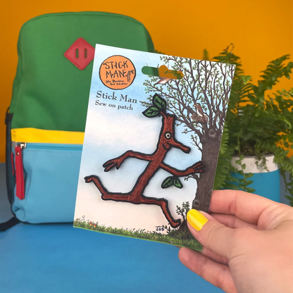 a person holding a book with a picture of a tree on it