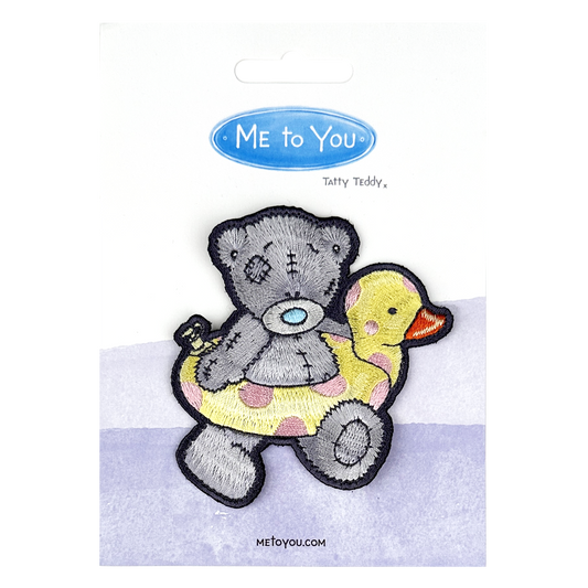 a picture of a teddy bear holding a rubber duck