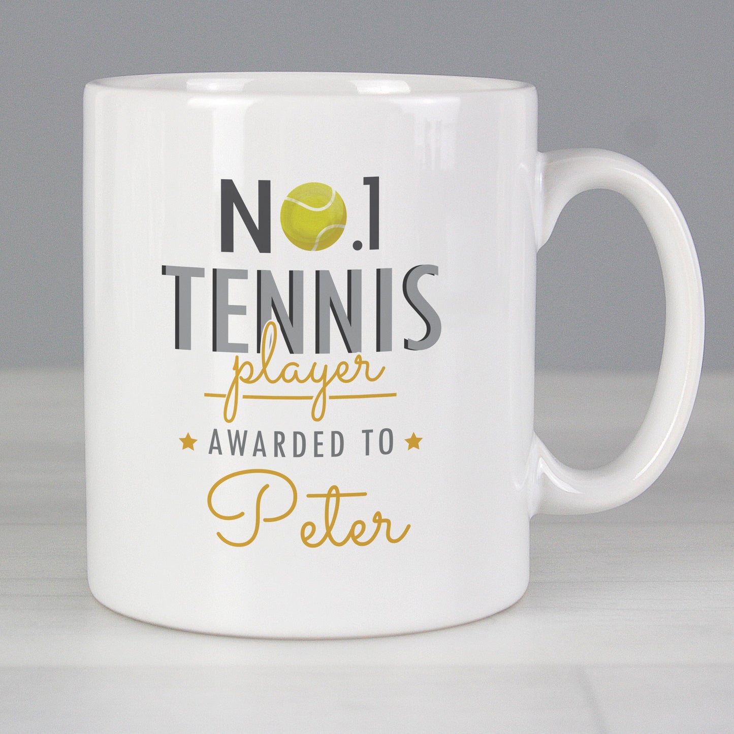 a white coffee mug with a tennis ball on it