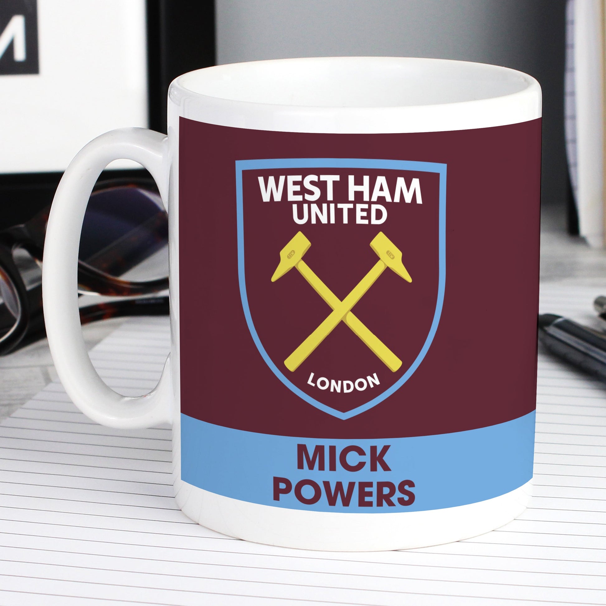 a coffee mug with a picture of two hammers on it