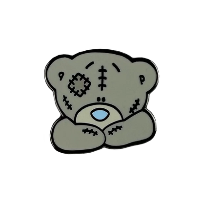 a sticker of a teddy bear with a cross on it