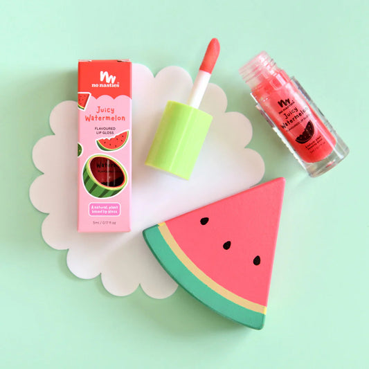 a watermelon lip balm next to a slice of watermelon