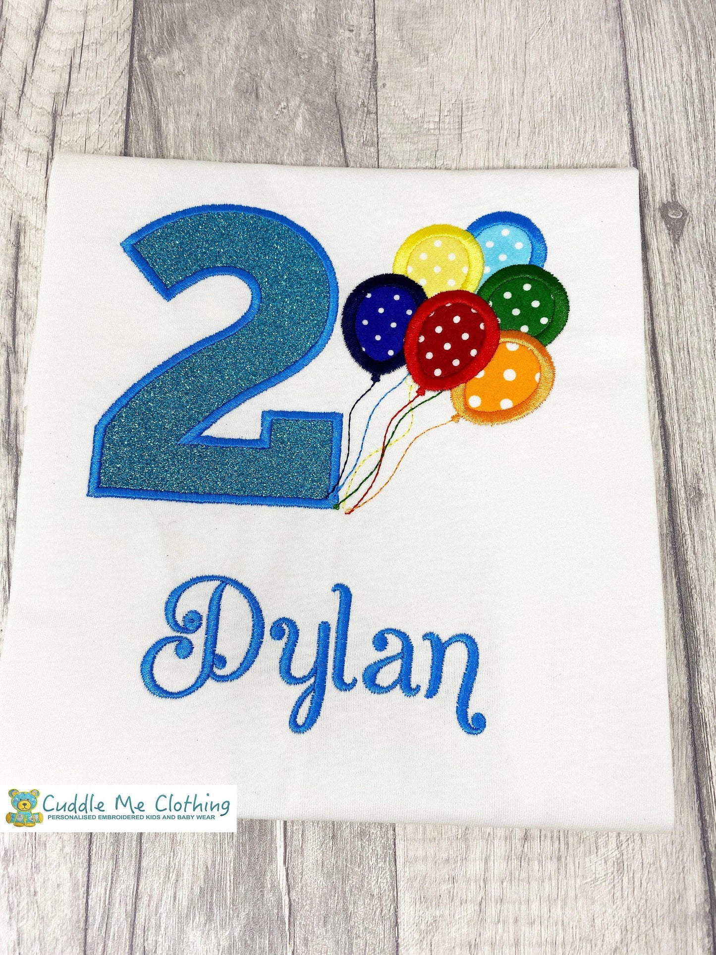 a birthday shirt with balloons and the number two on it
