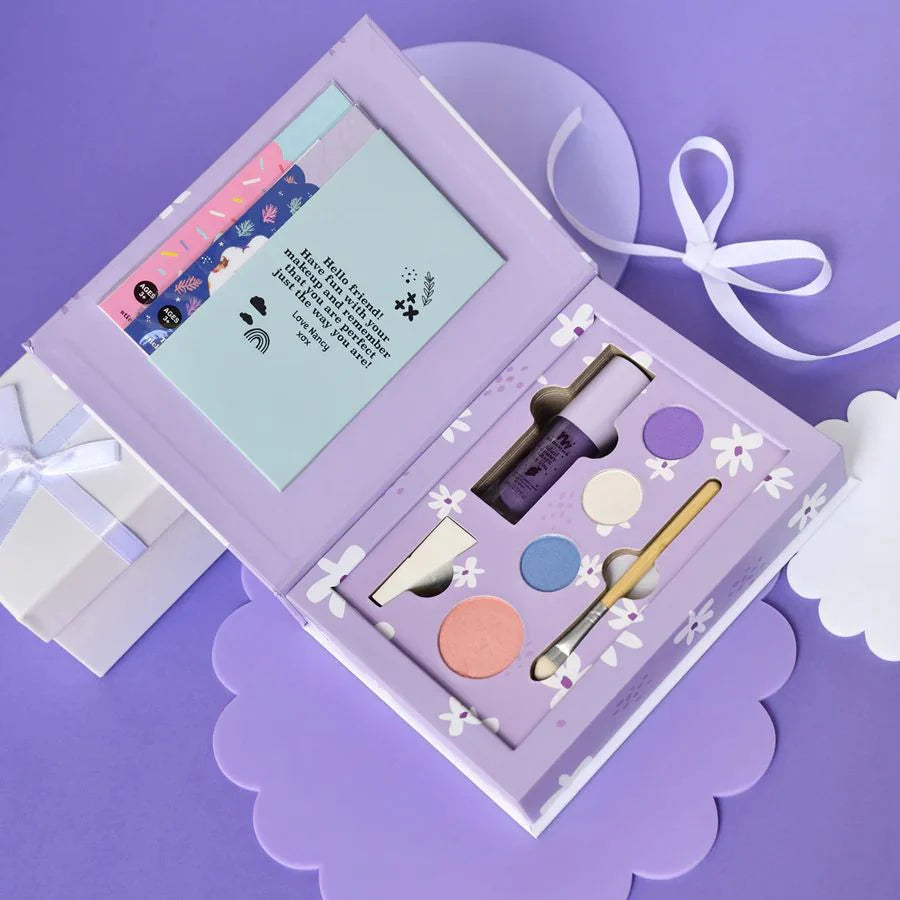 a purple box with a white bow and some items inside of it