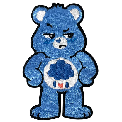 a blue teddy bear holding a soccer ball