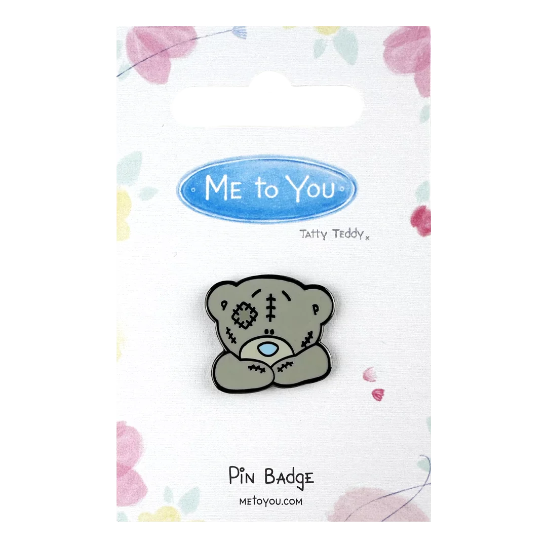 a pin badge with a teddy bear on it