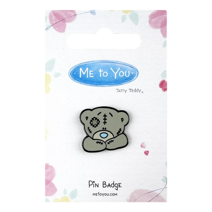 a pin badge with a teddy bear on it