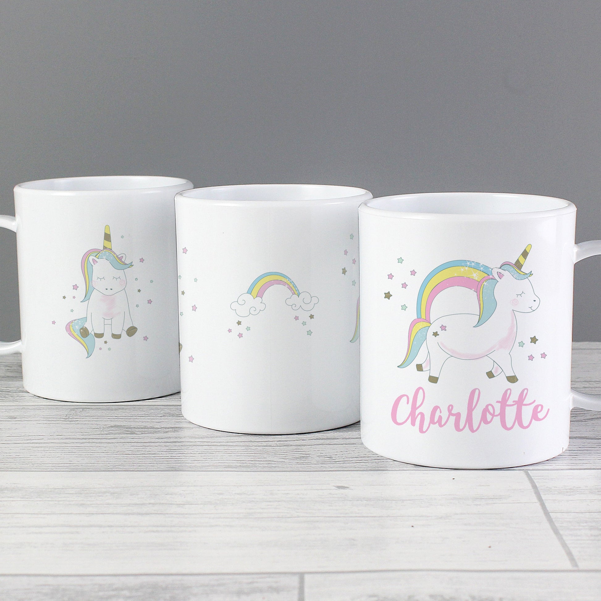 three coffee mugs with unicorns and rainbows on them