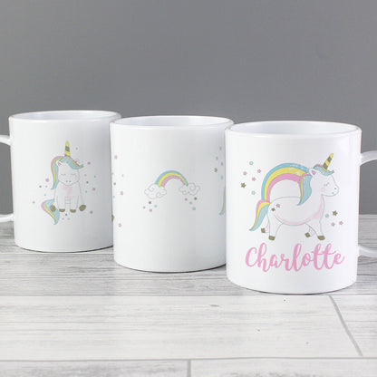 three coffee mugs with unicorns and rainbows on them