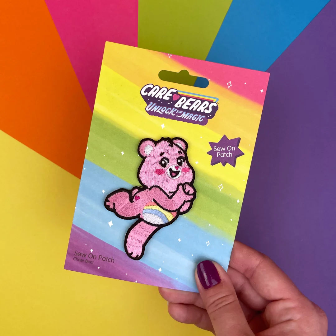 a hand holding a card with a pink bear on it