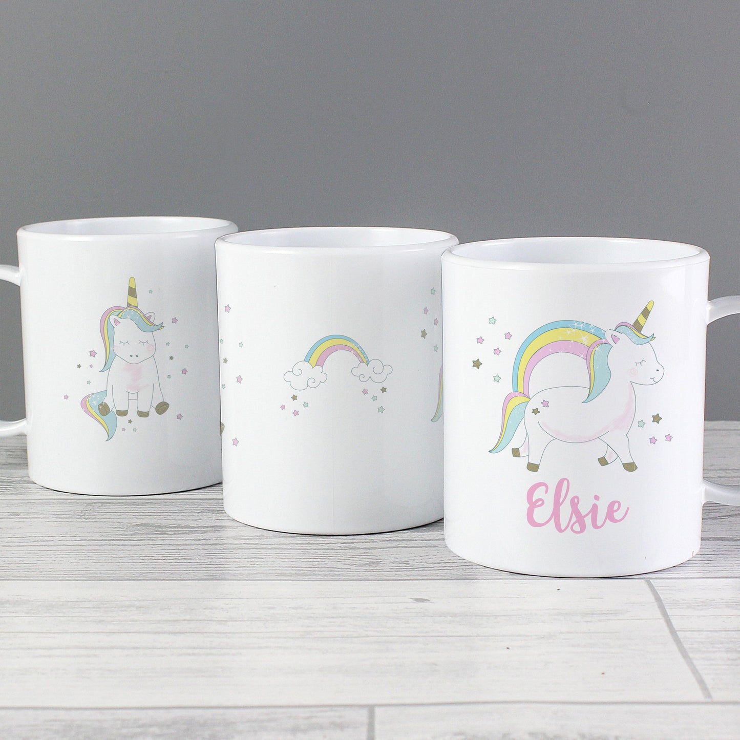three coffee mugs with unicorns and rainbows on them
