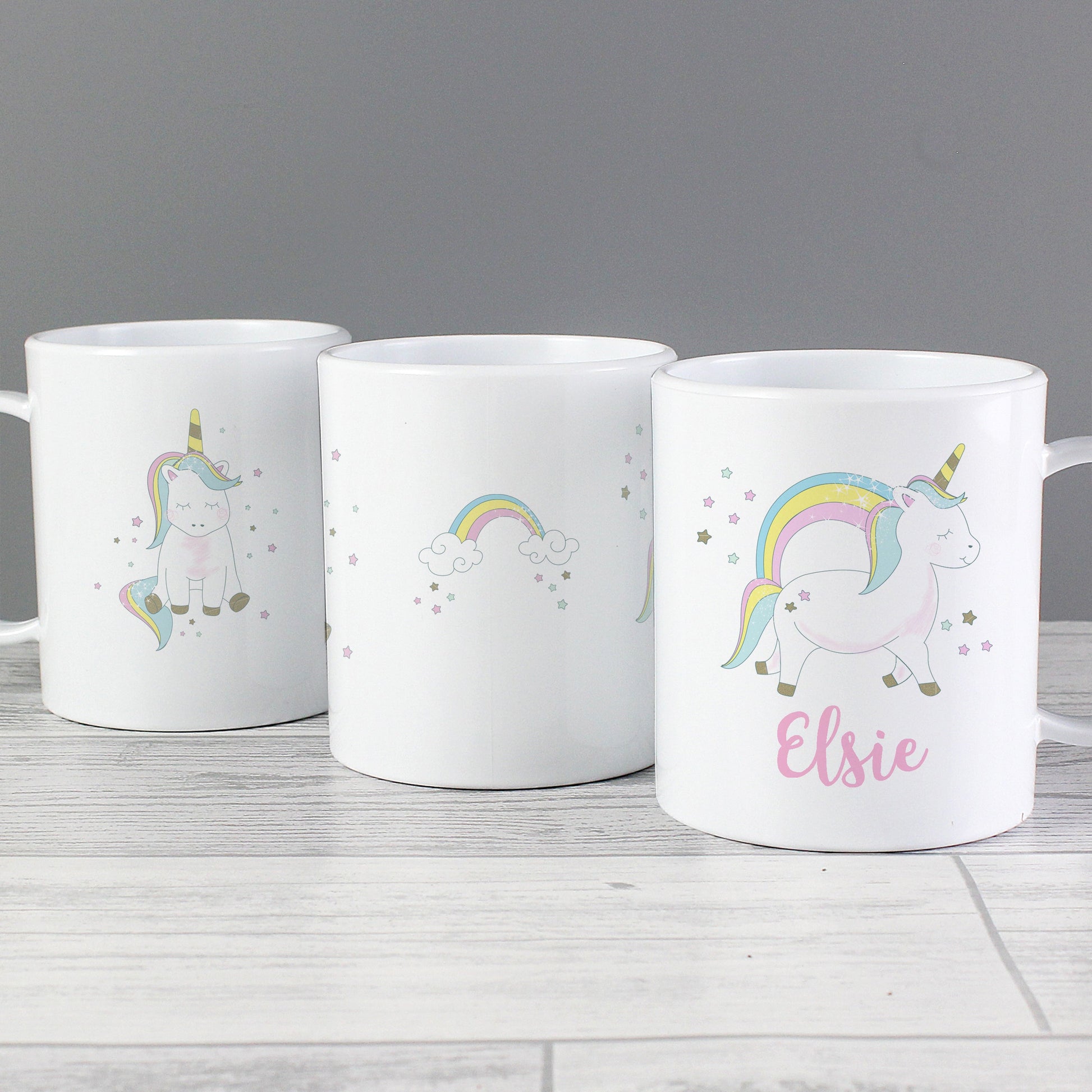 three coffee mugs with unicorns and rainbows on them