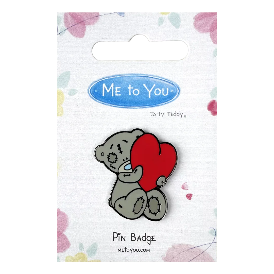 a pin badge with a koala holding a heart