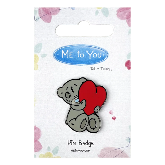 a pin badge with a koala holding a heart