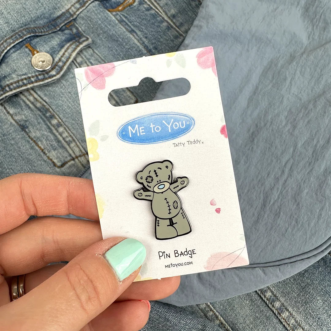 a person holding a sticker in their hand