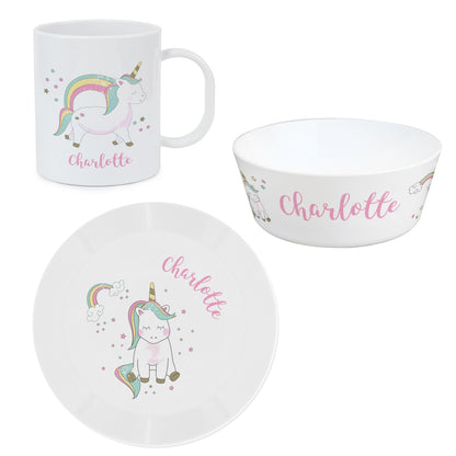 a cup, plate and bowl with a unicorn on it