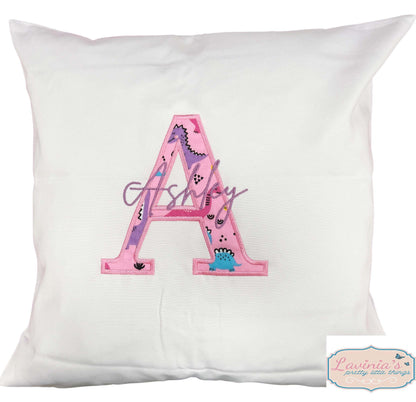 Embroidered pink dinosaur cushion